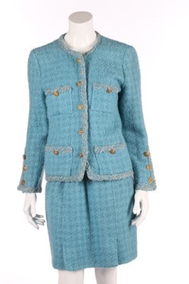 Lot 143 - A Chanel couture blue tweed suit, circa 1960,...