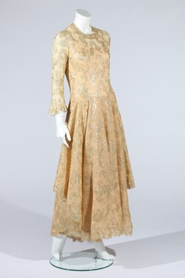 Lot 167 - A Chanel couture golden lace dress, circa 1974,...