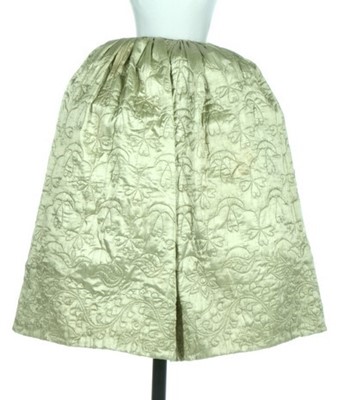 Lot 25 - A quilted pale green satin petticoat, second...