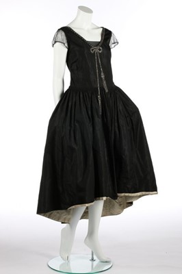 Lot 61 - A black taffeta robe de style, circa 1926,...