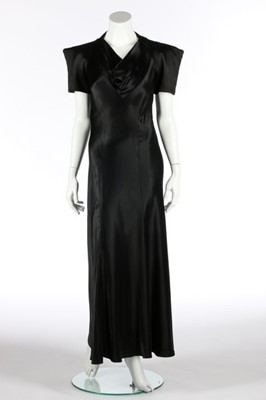 Lot 74 - A black satin bias cut evening gown,...