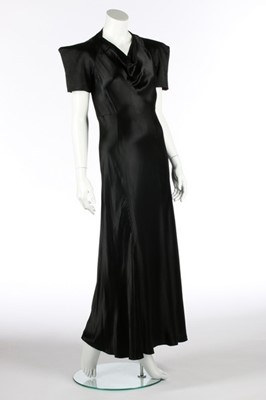 Lot 74 - A black satin bias cut evening gown,...