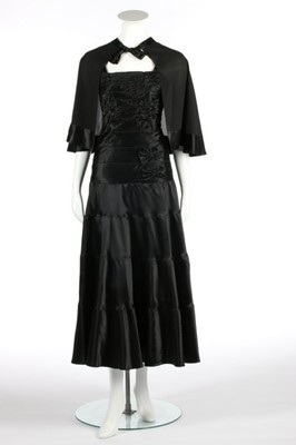 Lot 69 - An Alex black satin evening gown, circa 1930,...