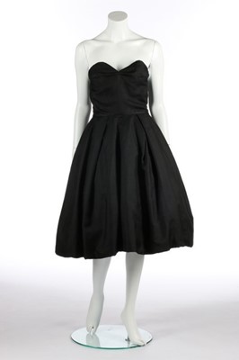 Lot 113 - A black silk faille cocktail dress, probably...