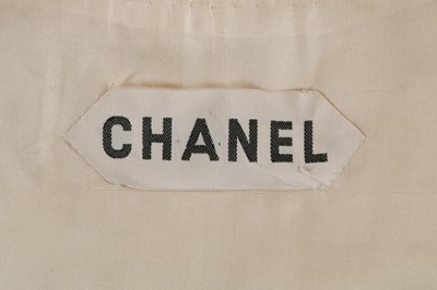Lot 27 - A Chanel couture ivory silk ensemble, 1974,...