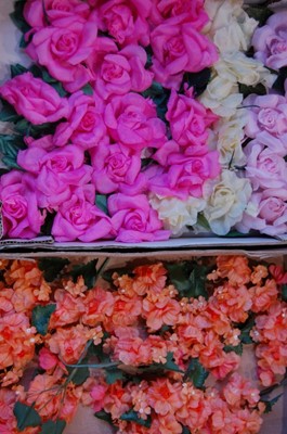 Lot 154 - Six boxes of silk flowers, mainly in pinks and...