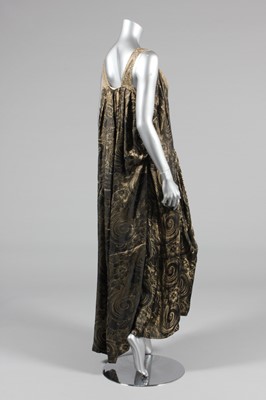 Lot 223 - A black and gold lame evening gown, early...