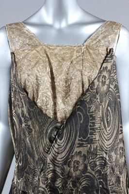 Lot 223 - A black and gold lame evening gown, early...