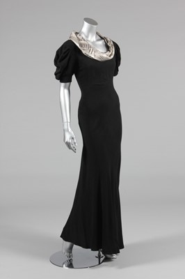 Lot 225 - A black satin-backed crepe bias cut evening...