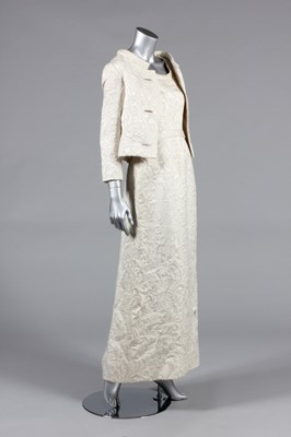 Lot 310 - A Pierre Balmain ivory brocatelle evening gown...