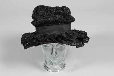 Lot 407 - A Schiaparelli woven black raffia hat with...