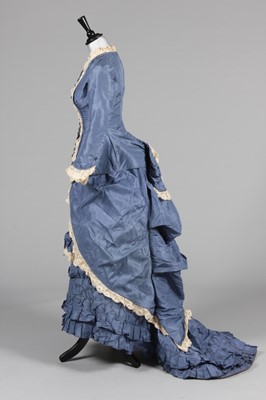 Lot 427 - A blue taffeta gown, late 1870s,...