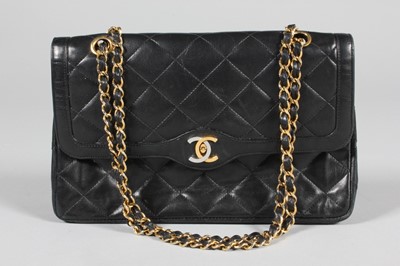 Lot 274 - A Chanel quilted black leather bag, circa 1990,...